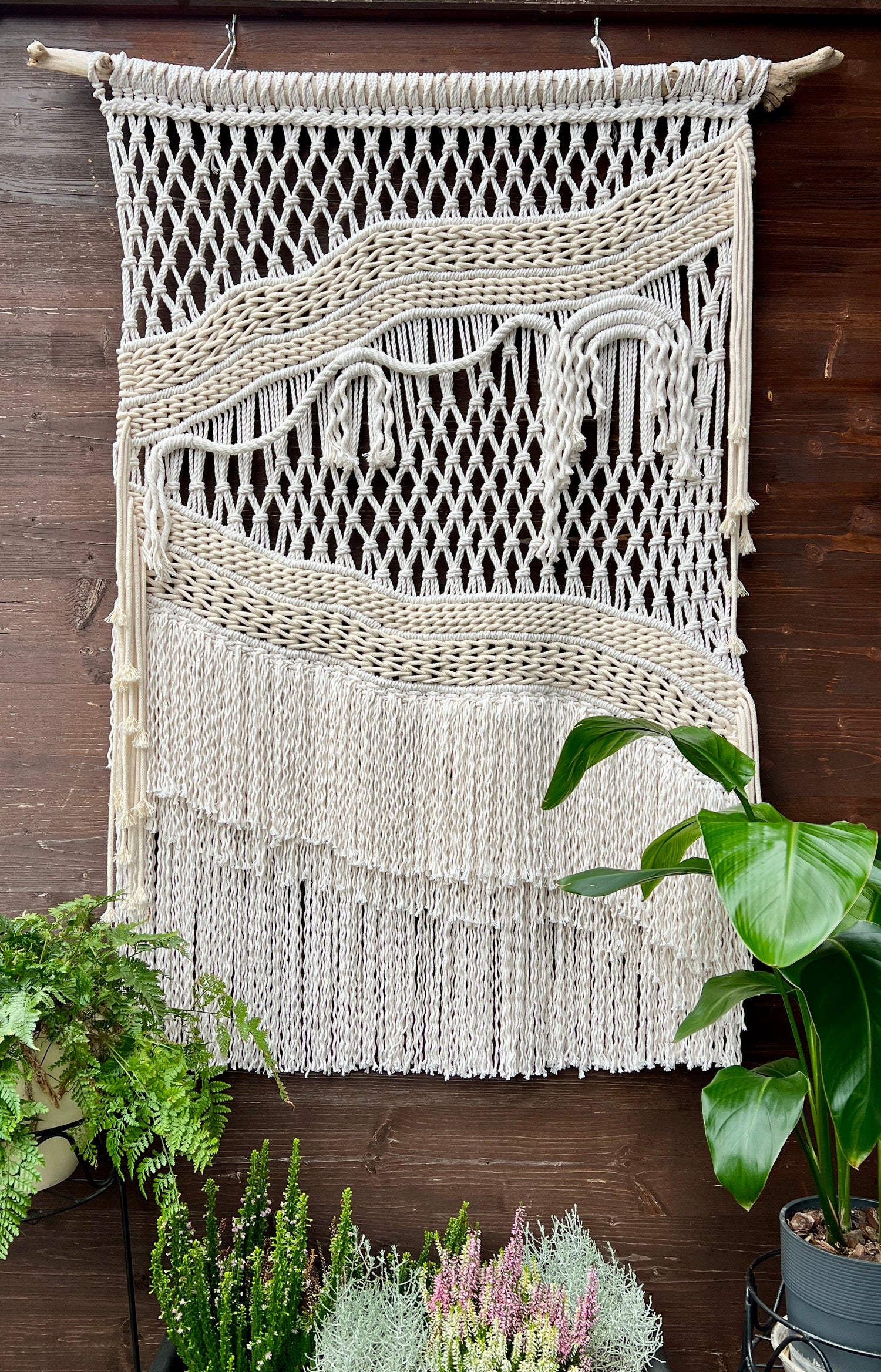Macrame Wall Hanging hang against wooden wall
