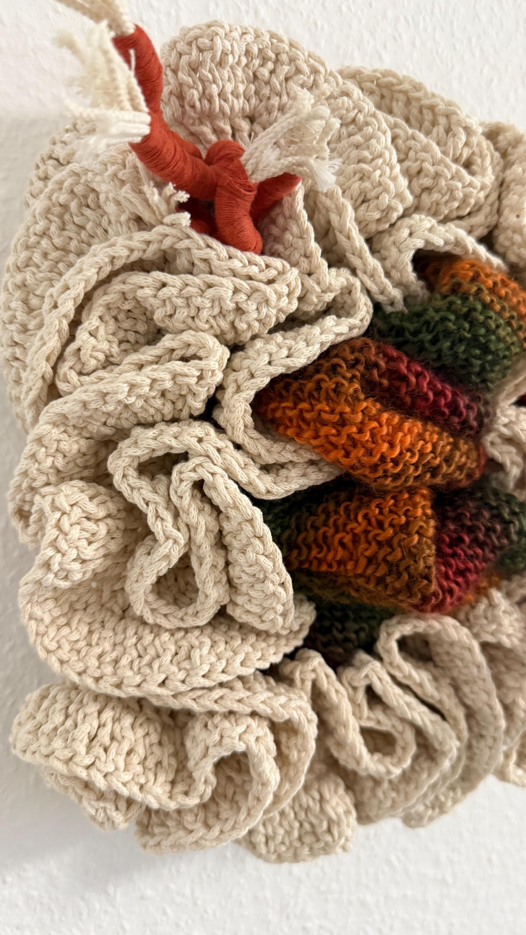 fiber  wall art with knitted pattern on a white background