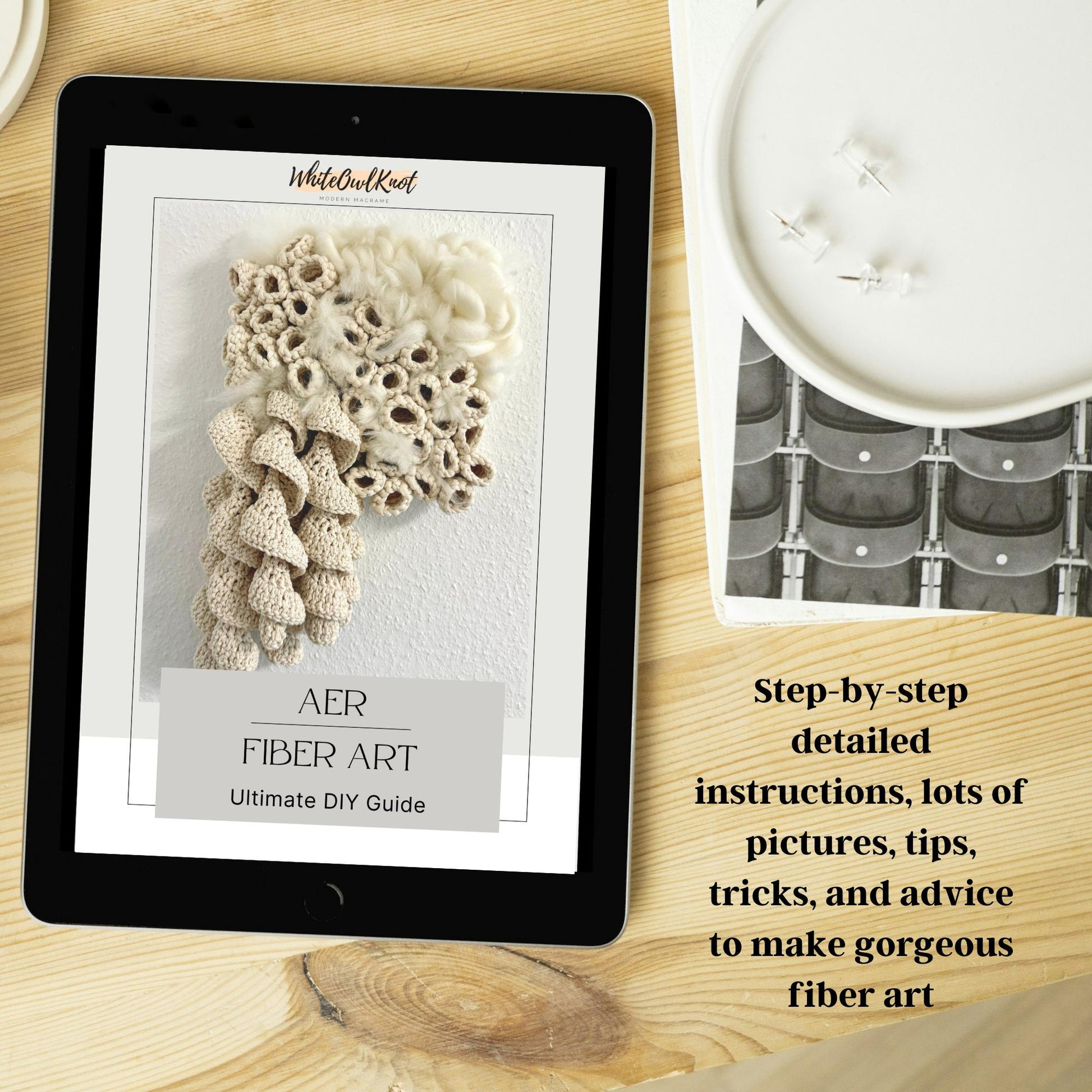 Tablet displaying a fiber art guide on a wooden surface with a crochet project.