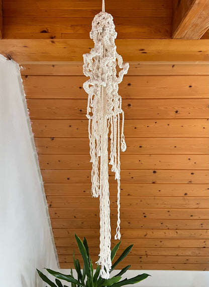 Macrame hanging decor against a wooden wall