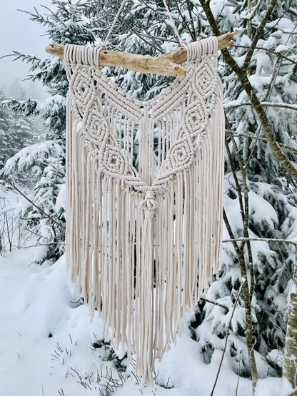 Macrame wall hanging in a snowy forest setting
