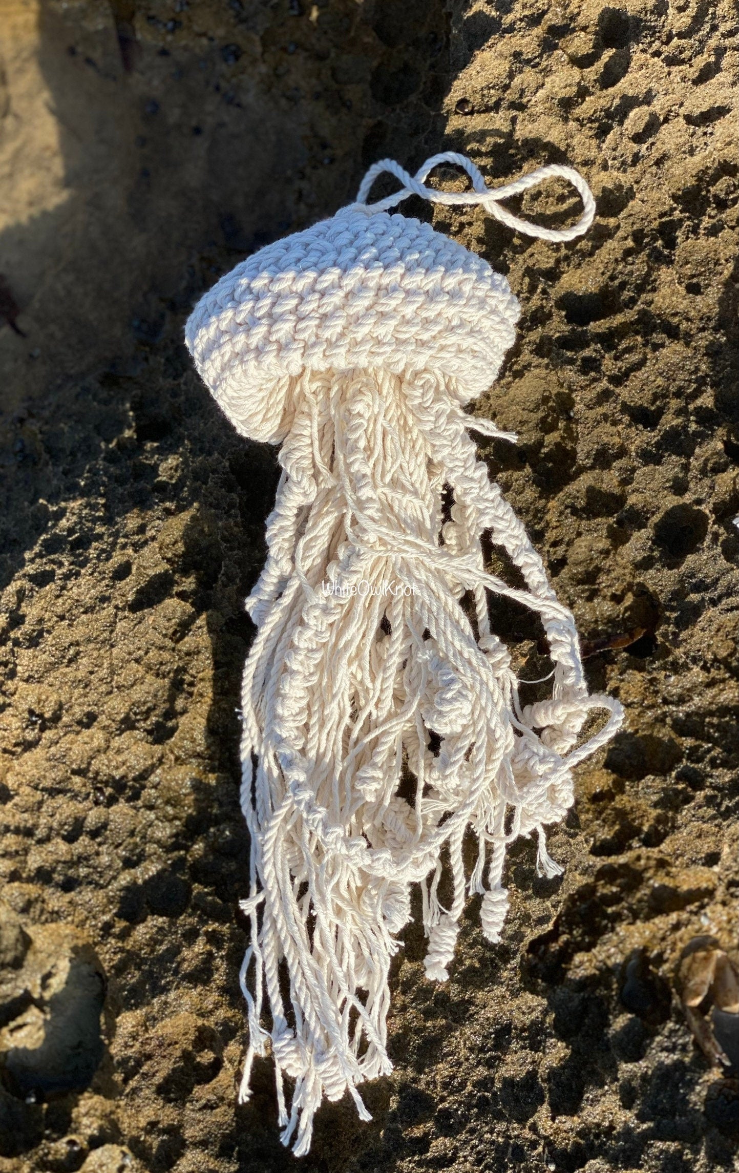 Decorative jellyfish ornament on a textured stone surface