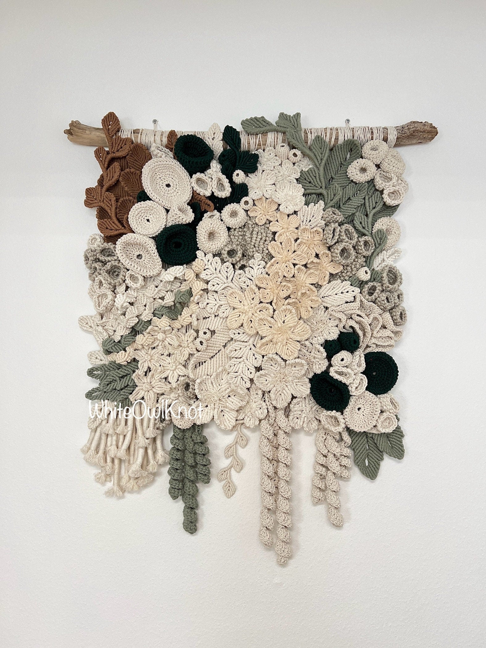 Textured Fiber wall hanging with floral patterns on a white background