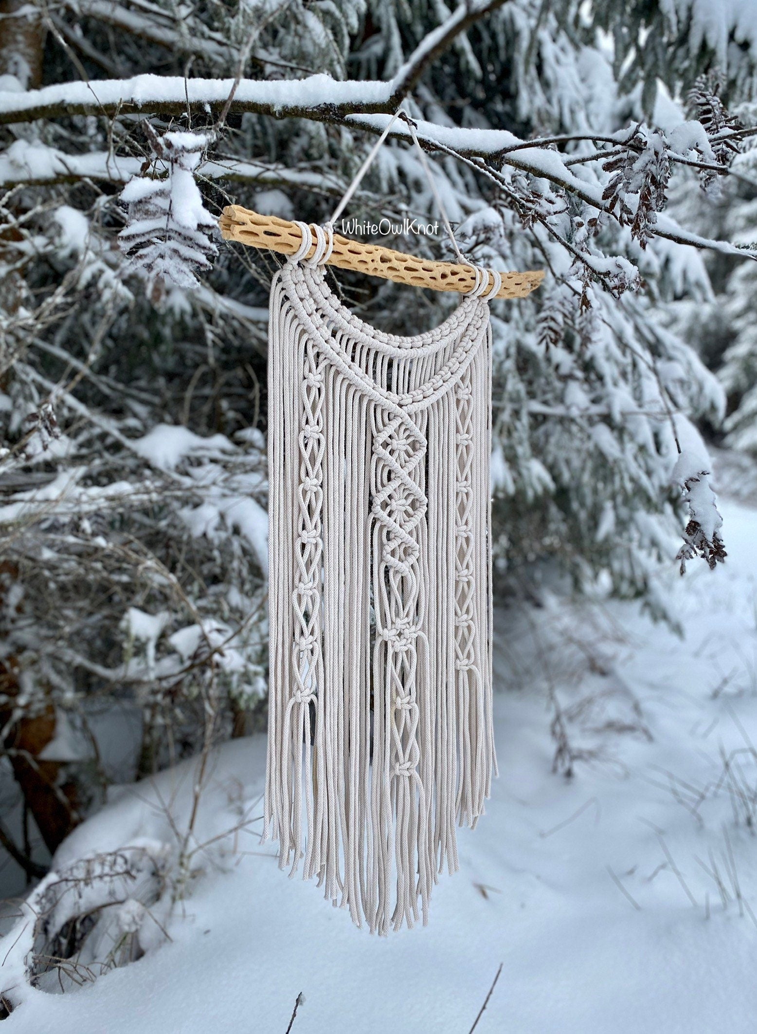 Macrame wall hanging in a snowy forest setting