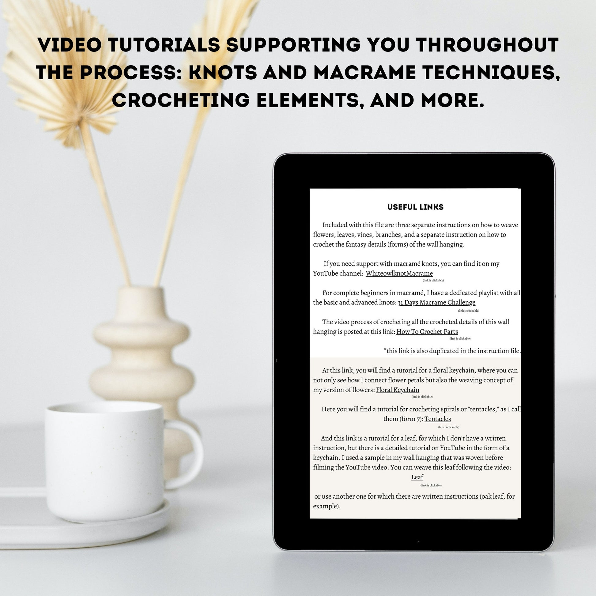 Tablet displaying text on a white surface with a cup and decorative elements.