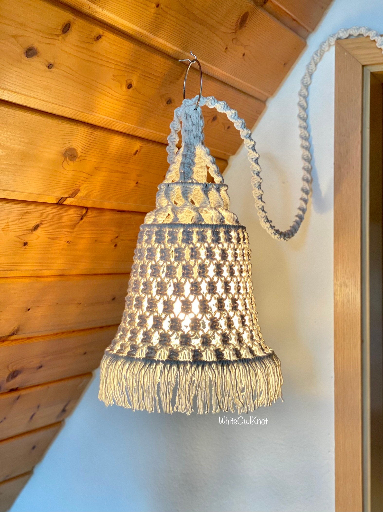 Handmade hanging lamp with fringes in a wooden interior setting