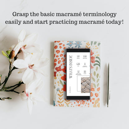 Floral notebook with a tablet on top, surrounded by flowers on a light background