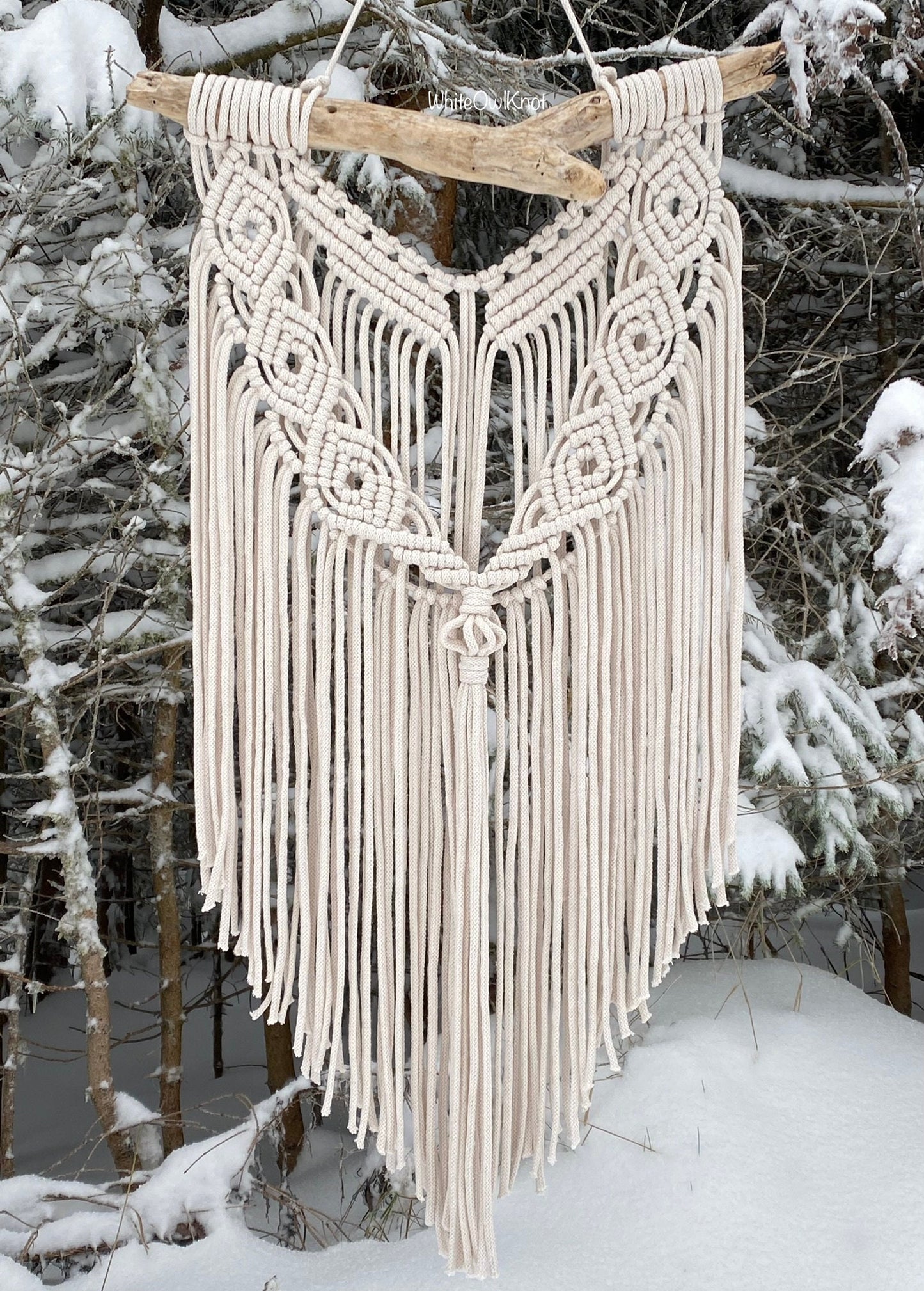 Macrame wall hanging in a snowy forest setting