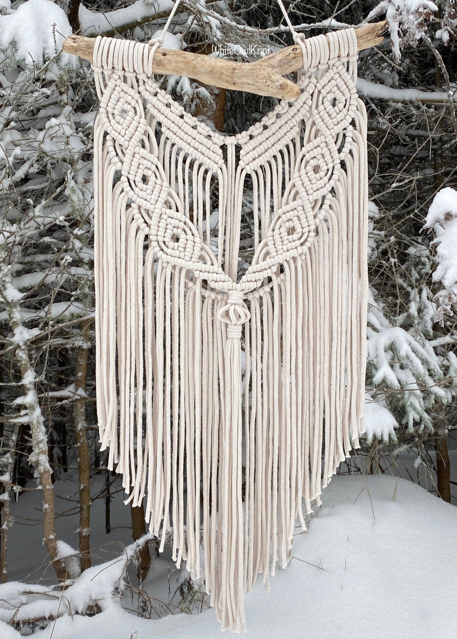 Macrame wall hanging in a snowy forest setting