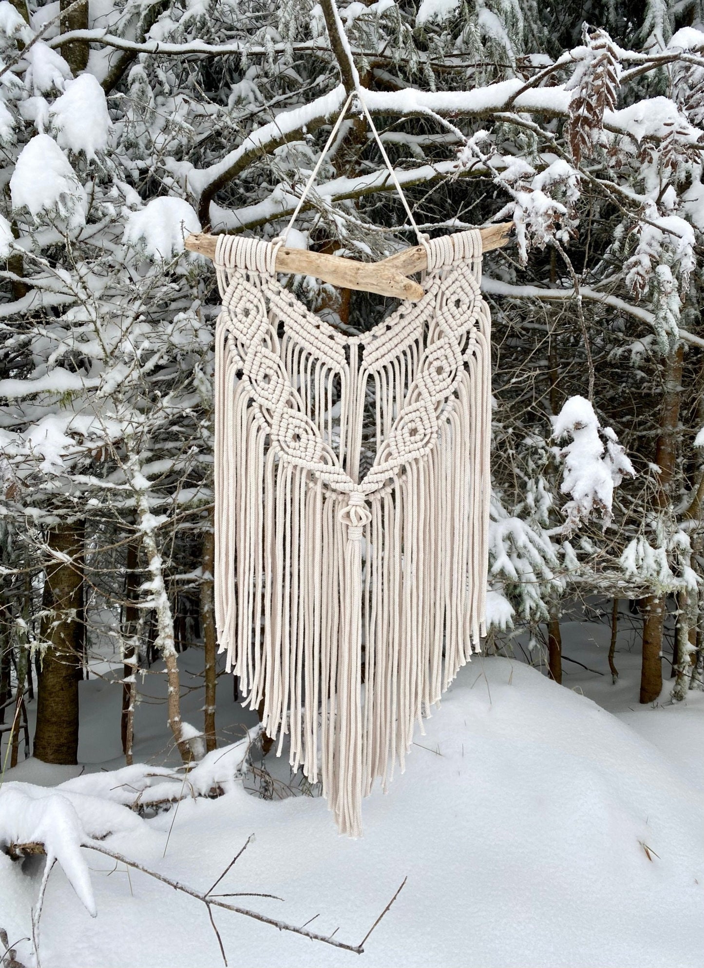Macrame wall hanging in a snowy forest setting