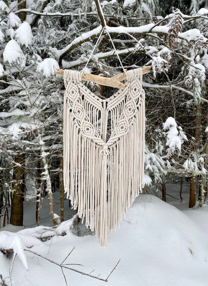 Macrame wall hanging in a snowy forest setting