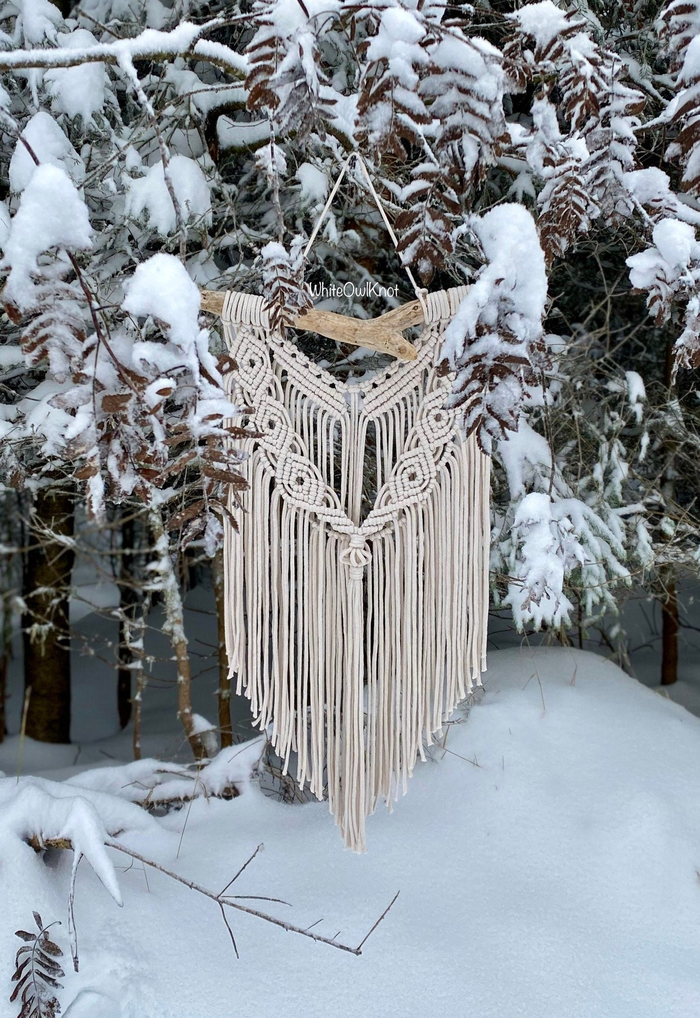 Macrame wall hanging in a snowy forest setting