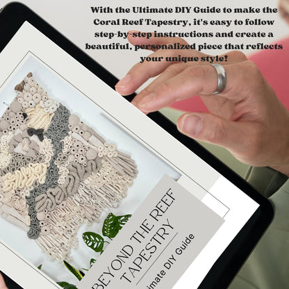 Hand holding a tablet displaying a coral reef tapestry design with text about a DIY guide.