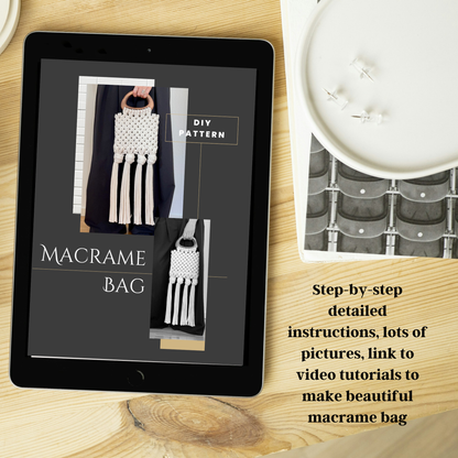 Tablet displaying a macrame bag pattern on a wooden surface with a candle and book.