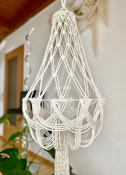 Macrame lampshade hanging indoors with a blurred background