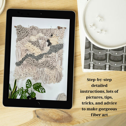 Tablet displaying fiber art on a wooden surface with text overlay