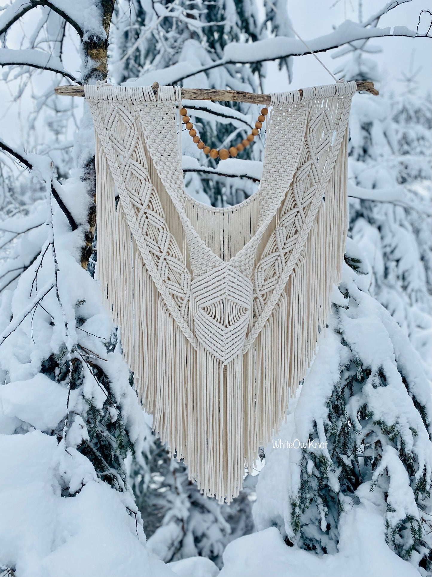 Macrame wall hanging in a snowy forest