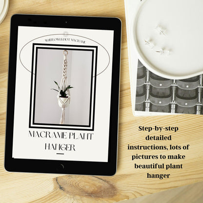 Tablet displaying a plant hanger tutorial on a wooden surface with a candle and decorative item.