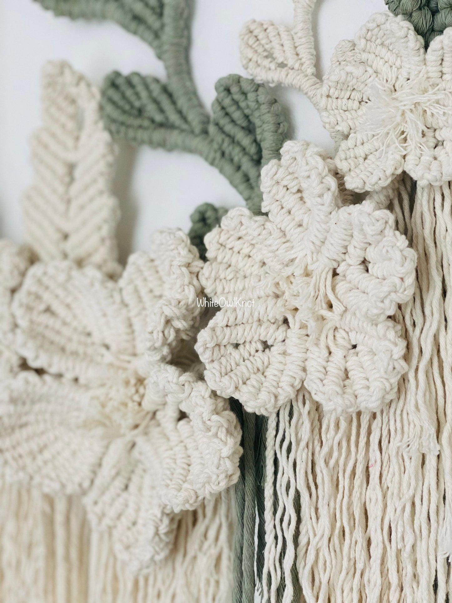 Close-up of macrame wall hanging with floral patterns