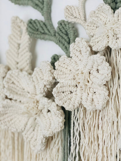 Close-up of macrame wall hanging with floral patterns