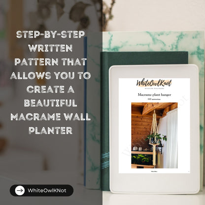 WhiteOwlKnot macrame plant hanger pattern book on a white surface with blurred background