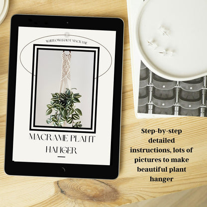 Tablet displaying a macrame plant hanger tutorial on a wooden surface with a candle and plant in the background.