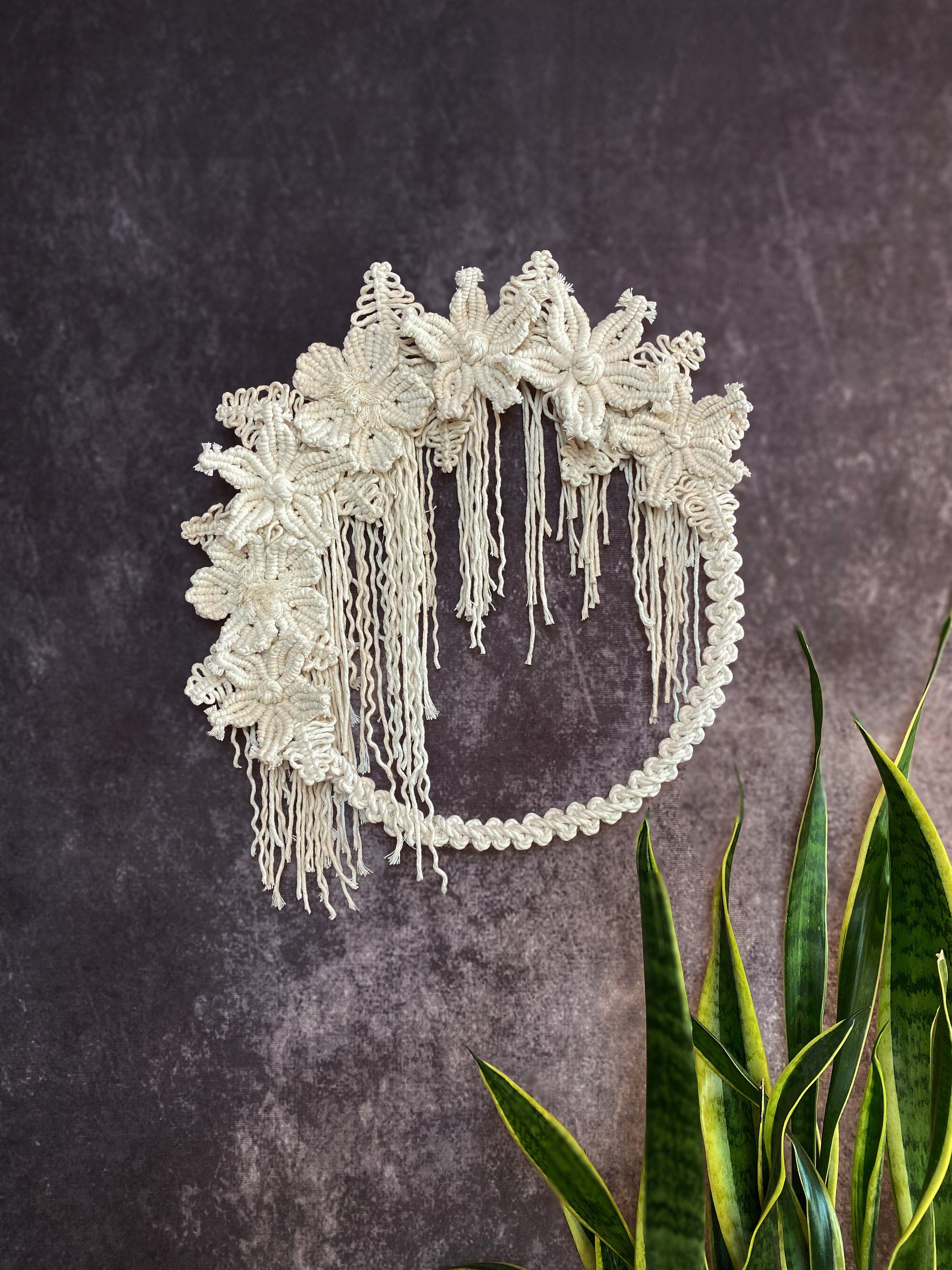 Decorative headband with floral details on a textured dark background