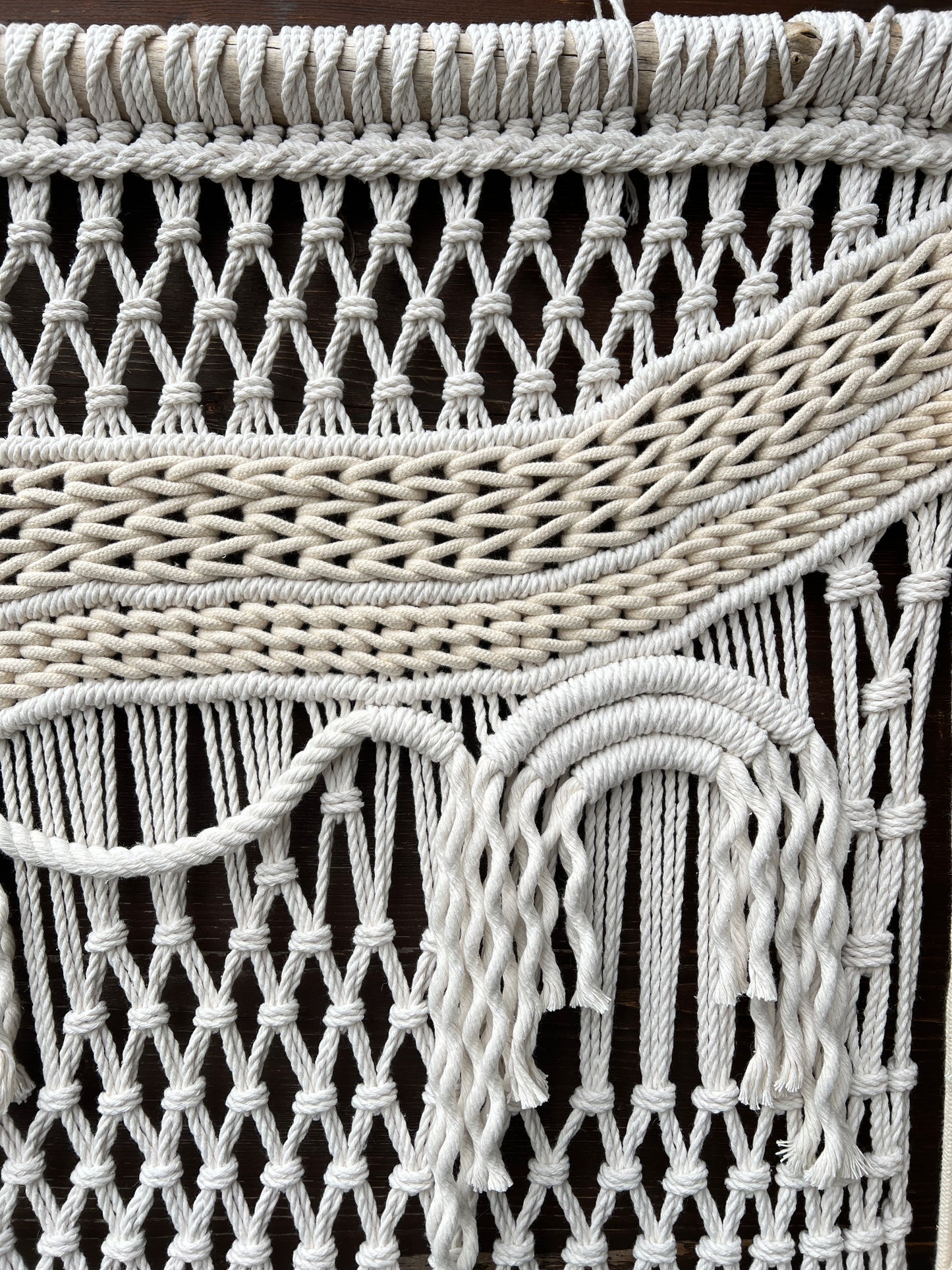 Close-up of a woven white basket with a dark background