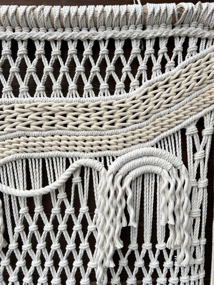 Close-up of a woven white basket with a dark background