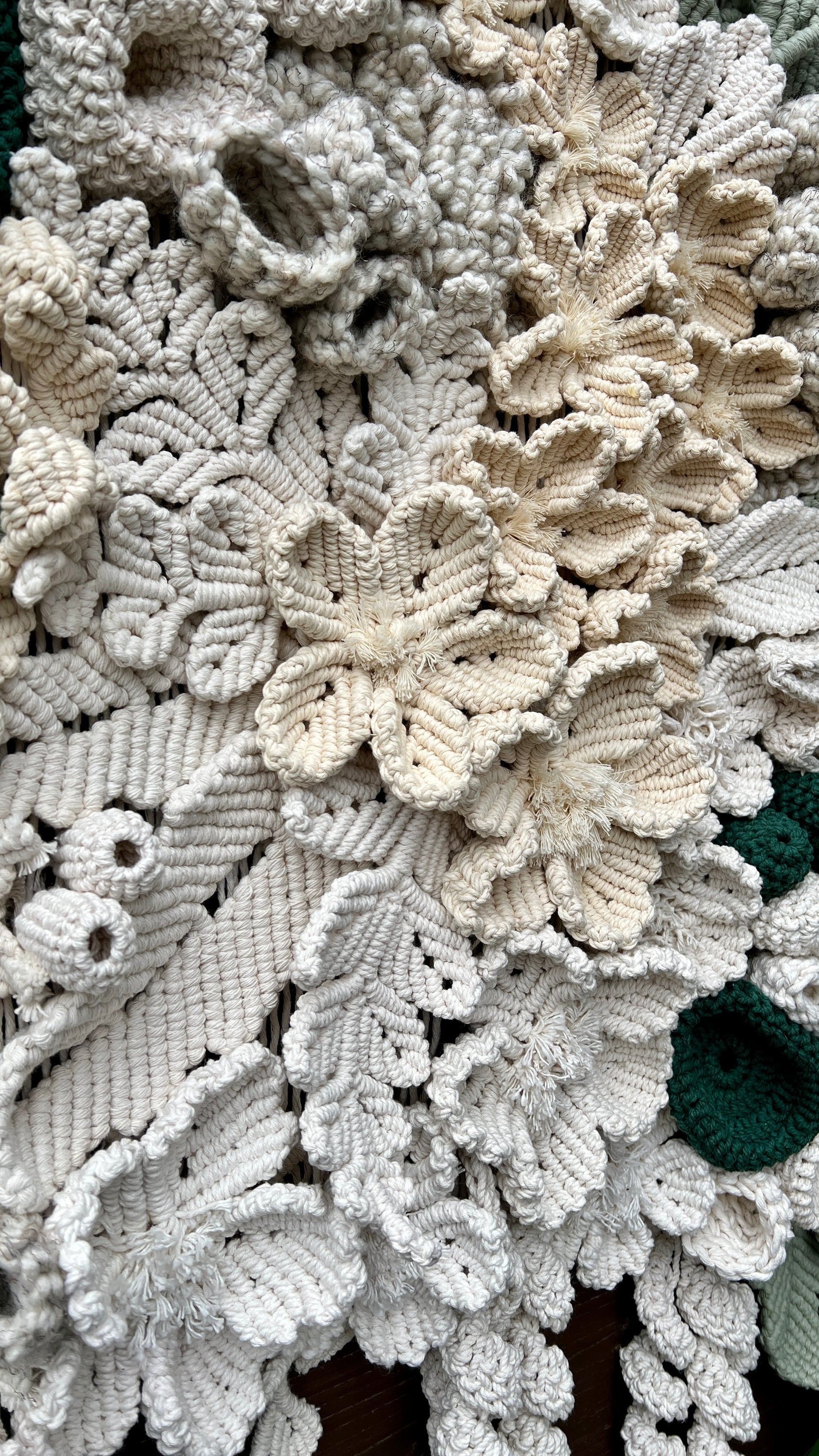 Close-up of a textured fabric with floral patterns in neutral colors.