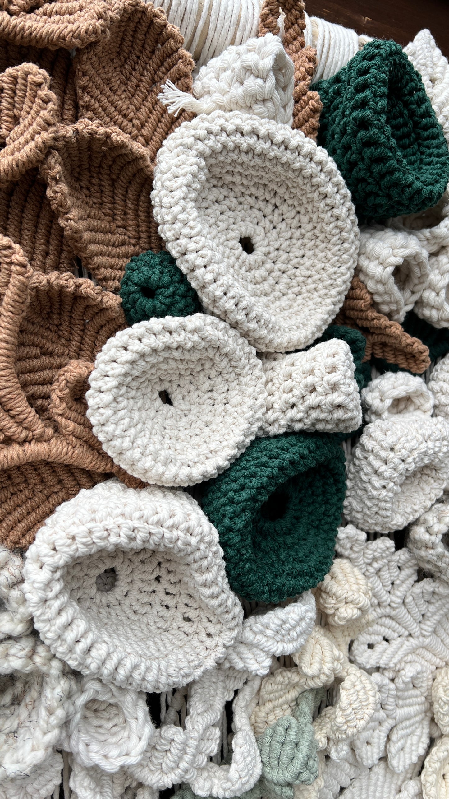 Close-up of crocheted coral reef details in various colors including white, green, and brown.