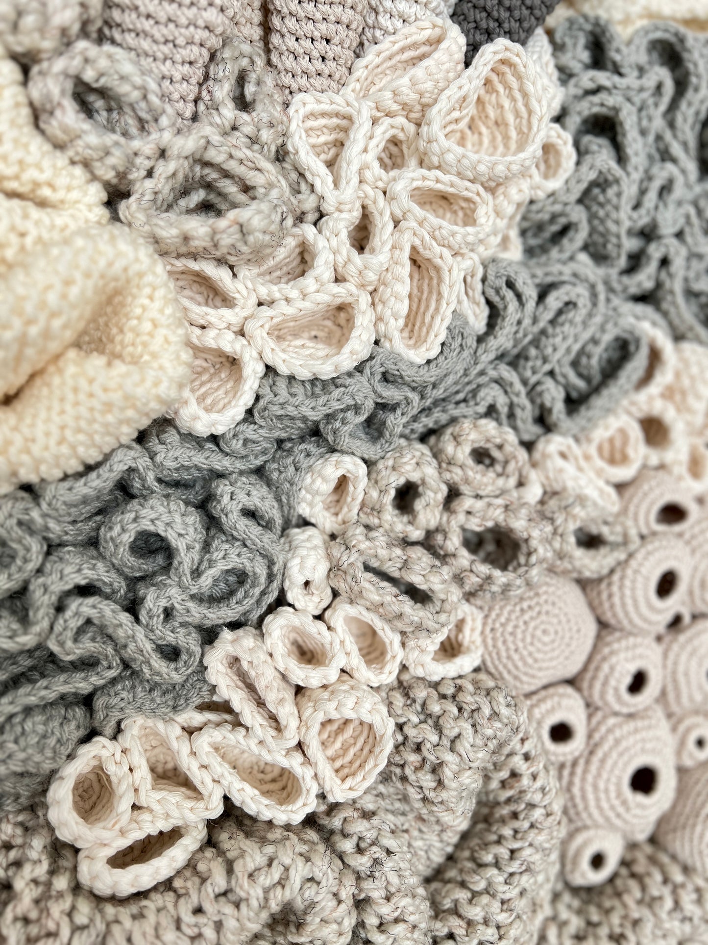 Close-up of a textured fabric with coral reef details in neutral colors.