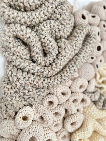 Close-up of a textured beige fabric with circular patterns and buttons.
