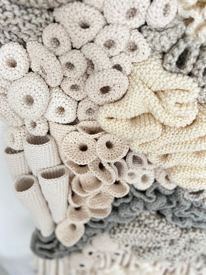 Close-up of textured beige and gray textile pieces on a white background