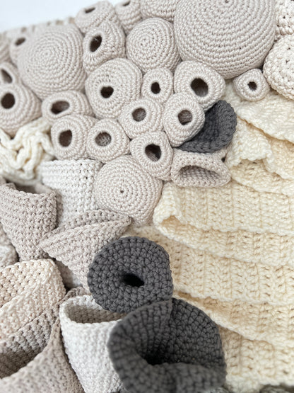 Close-up of a textured crochet coral reef details with circular and leaf-shaped patterns.