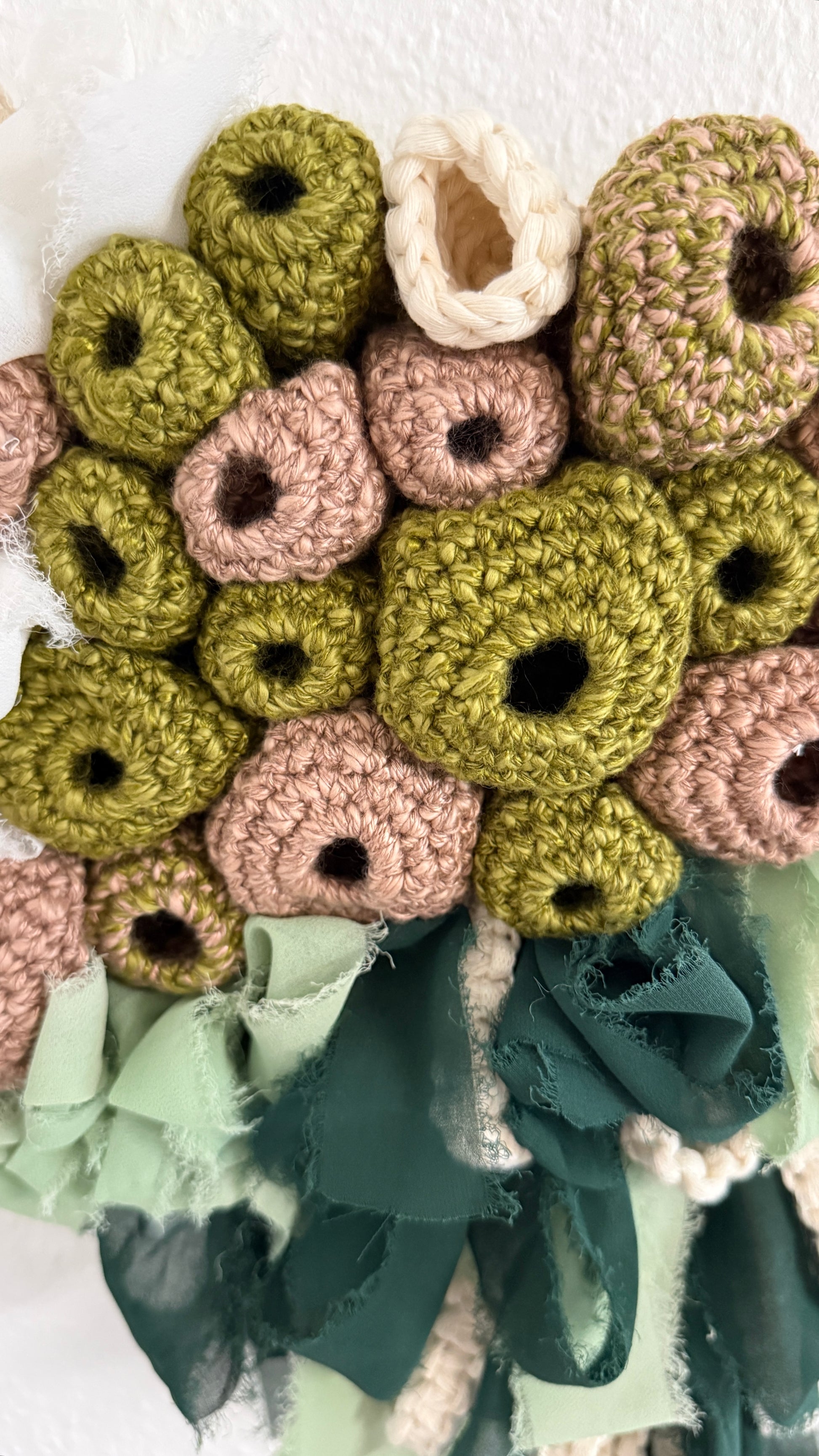 Collection of crocheted flowers in various colors on a white background