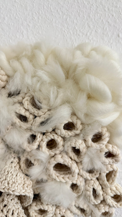 Close-up of textured white fabric with crochet patterns