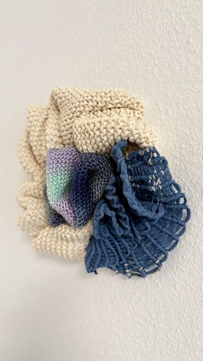 Knitted details of small wall tapestrie on a light background