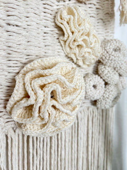 Close-up of a textured woven wall hanging with natural fiber patterns.