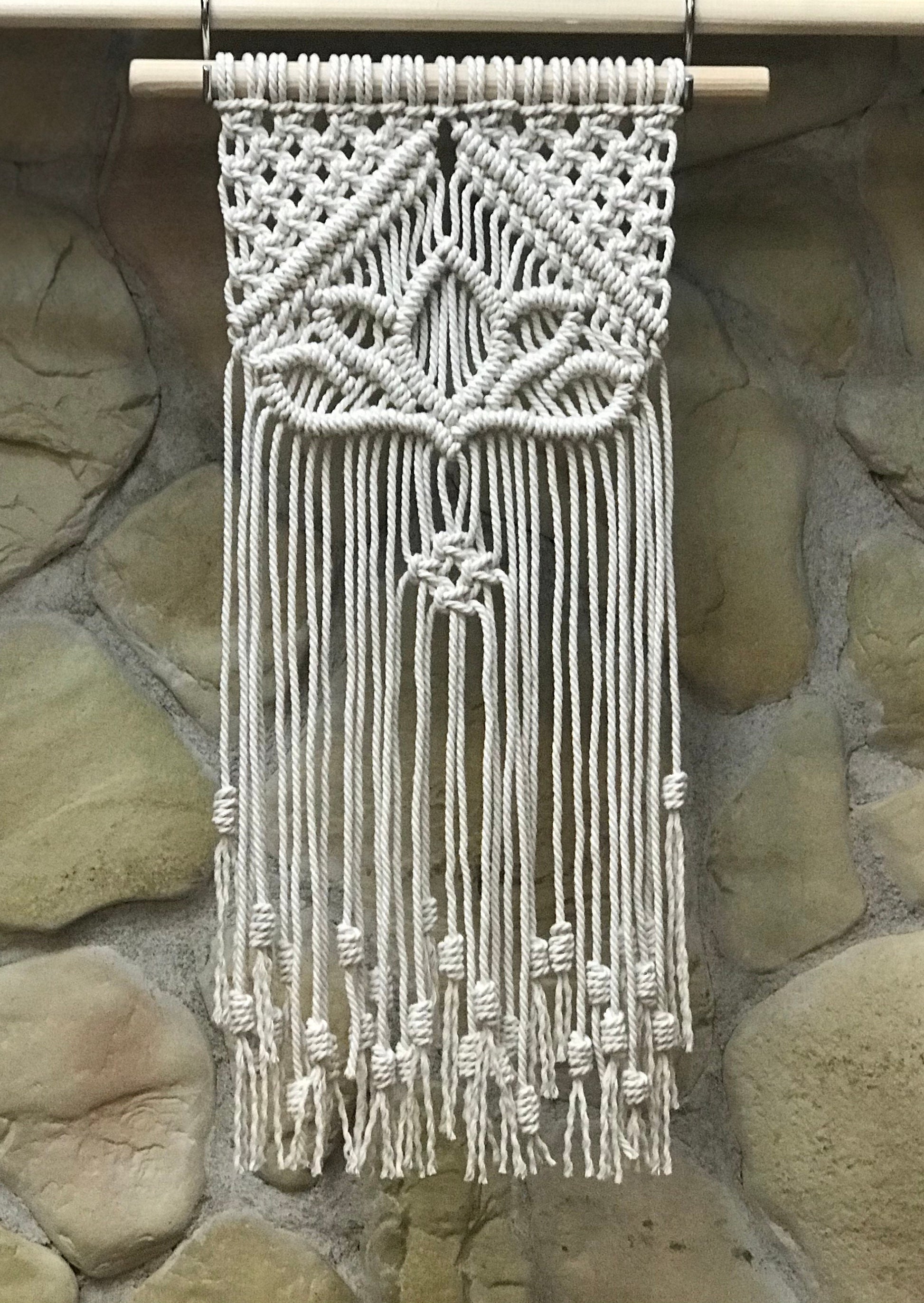 Macrame wall hanging on a stone wall