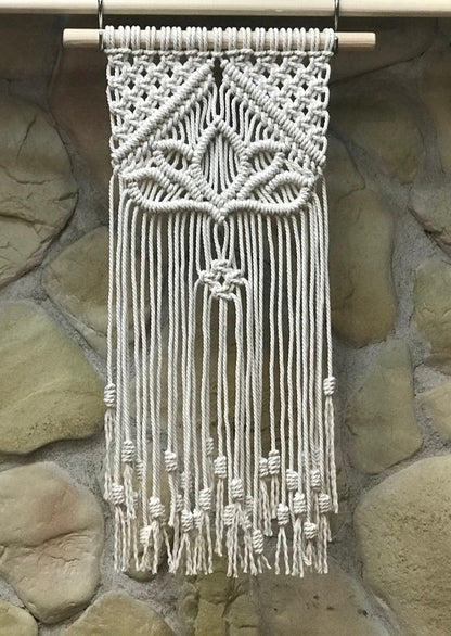 Macrame wall hanging on a stone wall