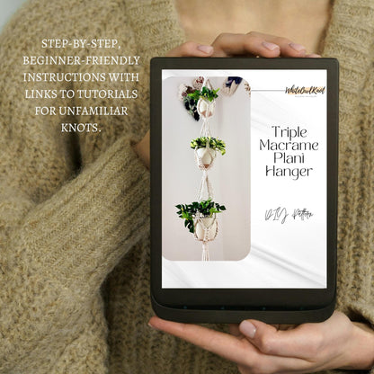 Person holding a tablet displaying a triple macrame plant hanger pattern with text about instructions.