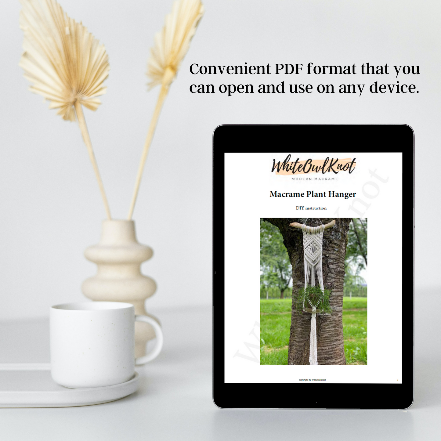 Tablet displaying a PDF on a white surface with decorative elements