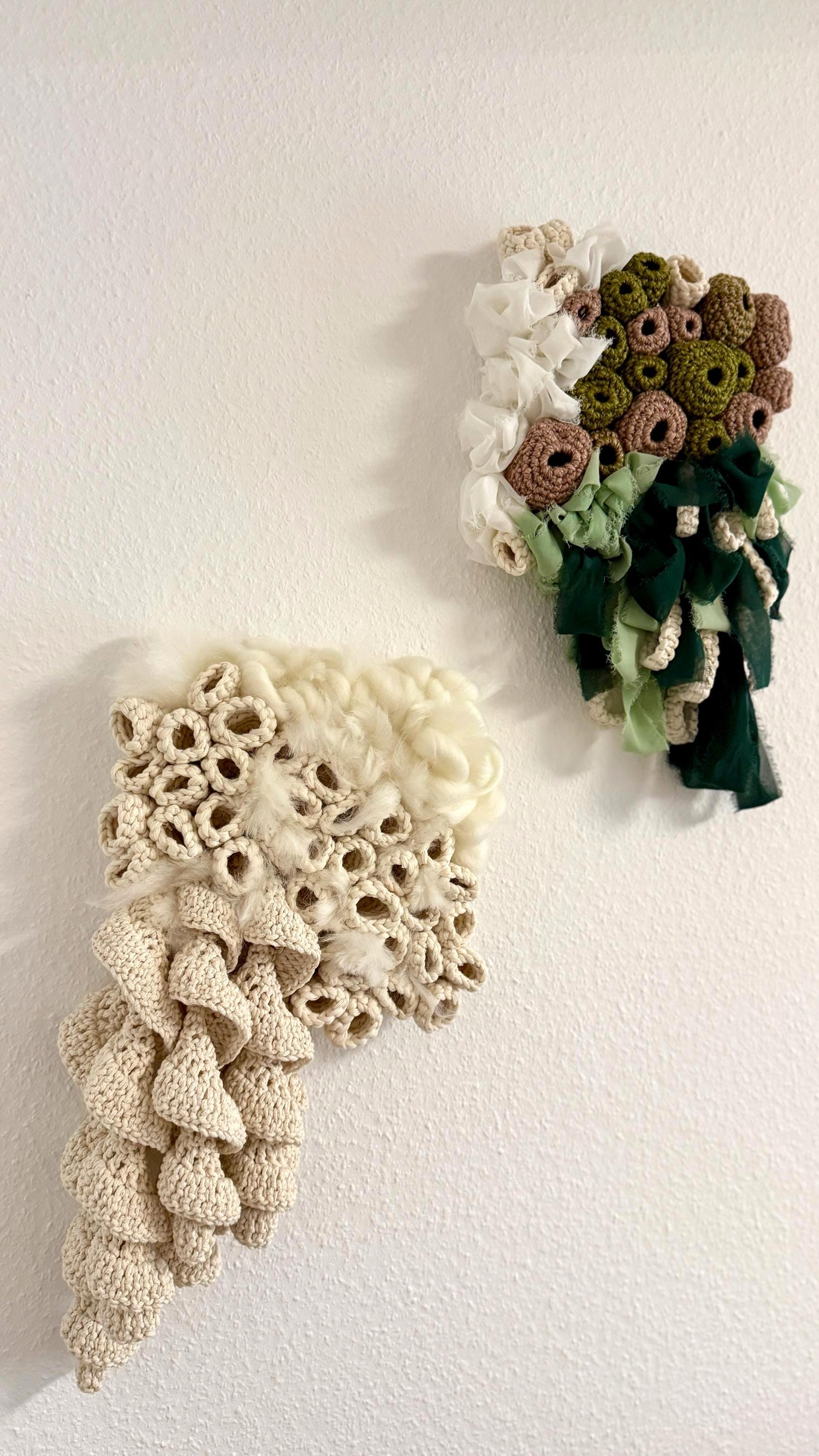 Two crocheted wall art pieces on a white background