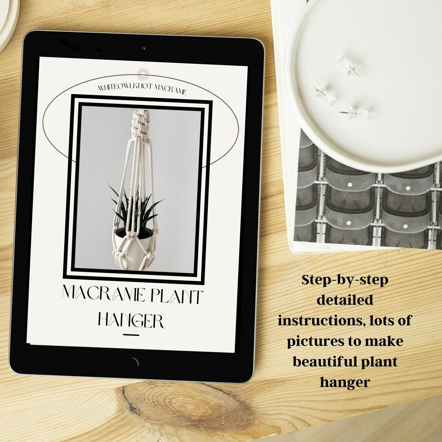Tablet displaying a macrame plant hanger tutorial on a wooden surface with a candle and decorative item.