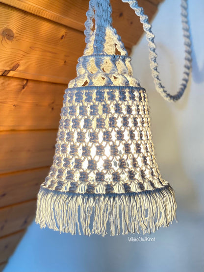 Macrame chandelier with fringes against a wooden wall