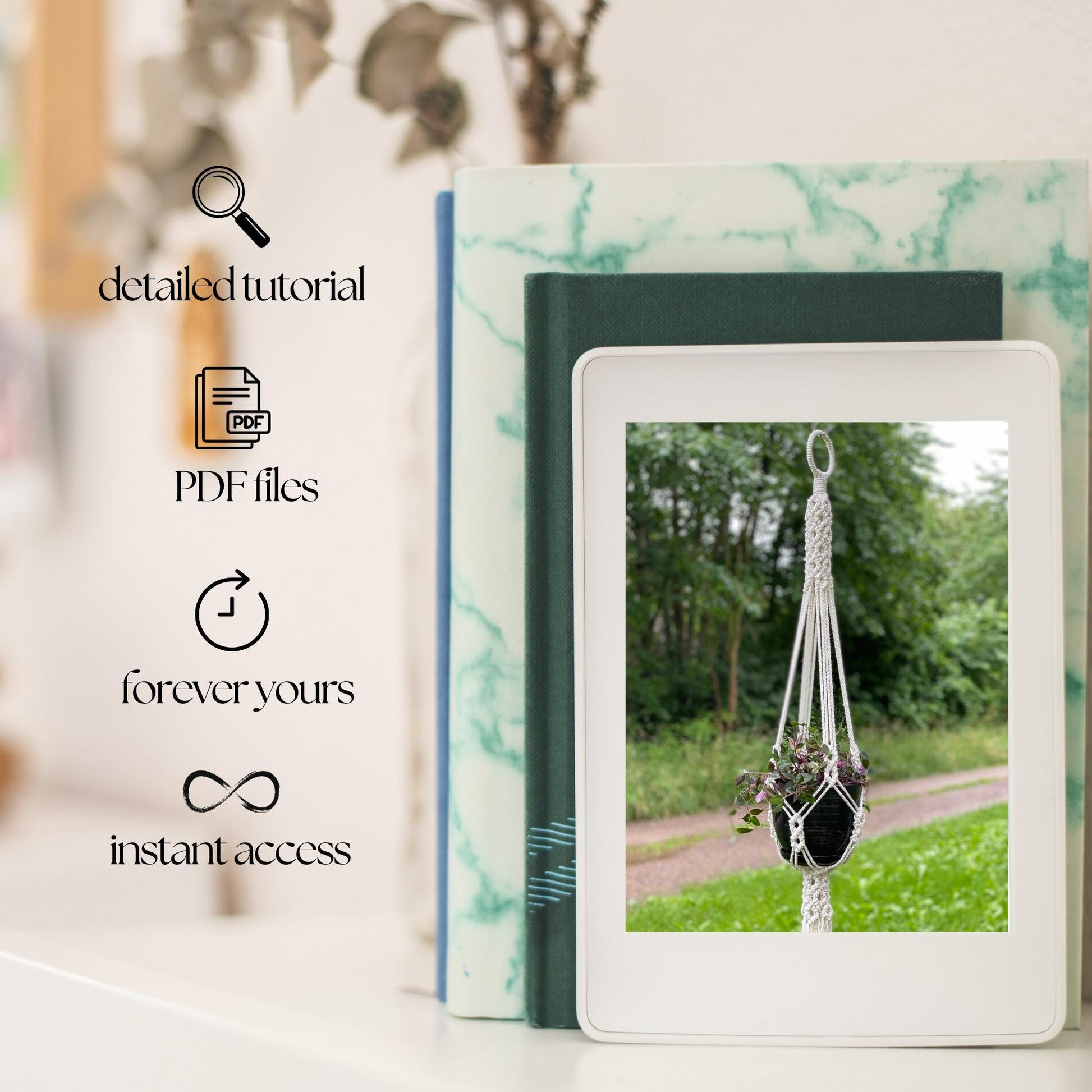 Digital product with a screen displaying a macrame plant hanger, surrounded by books on a blurred natural background.
