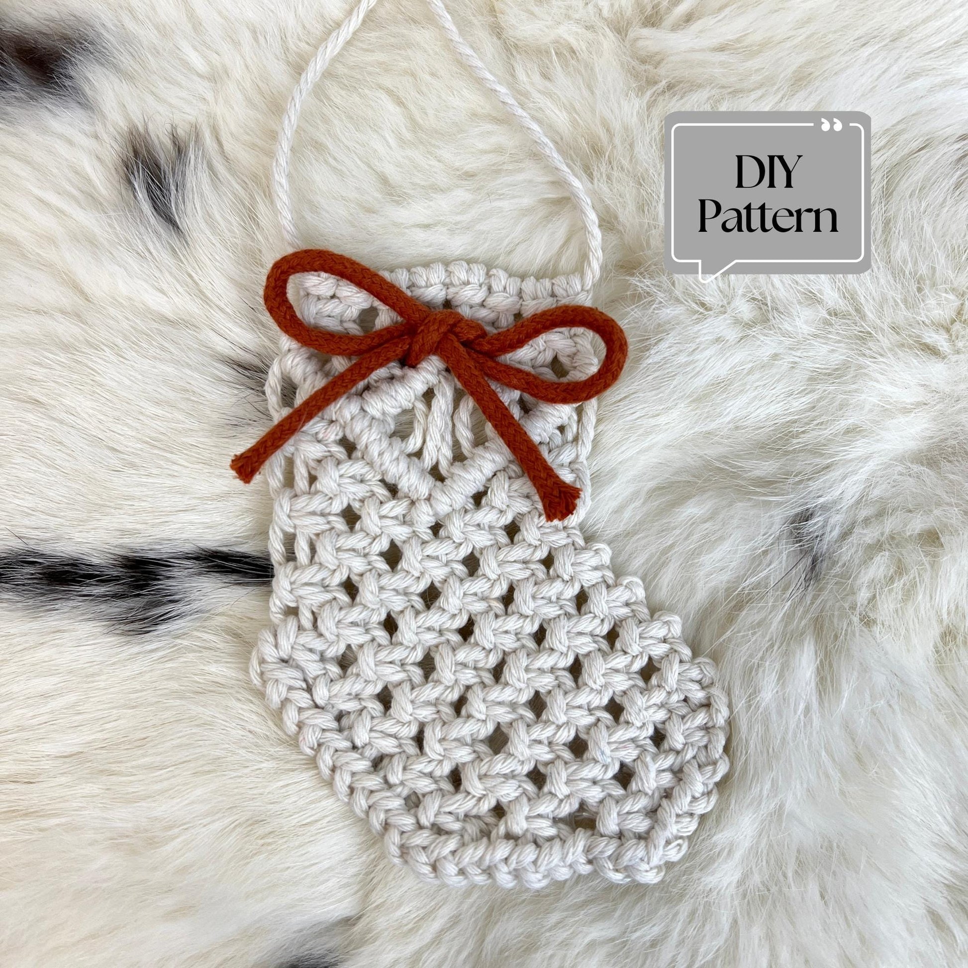 Macrame Christmas Stocking with a bow on a fur background, labeled 'DIY Pattern'.