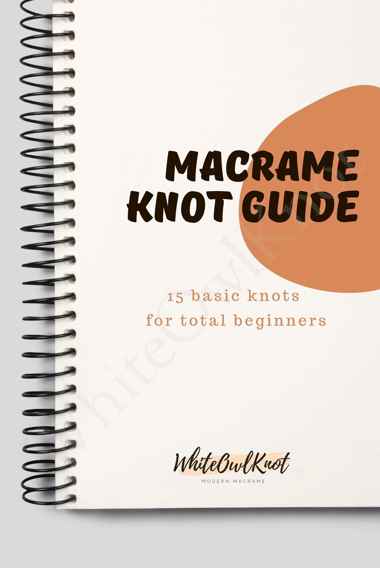 Macrame knot guide book with spiral binding on a white background