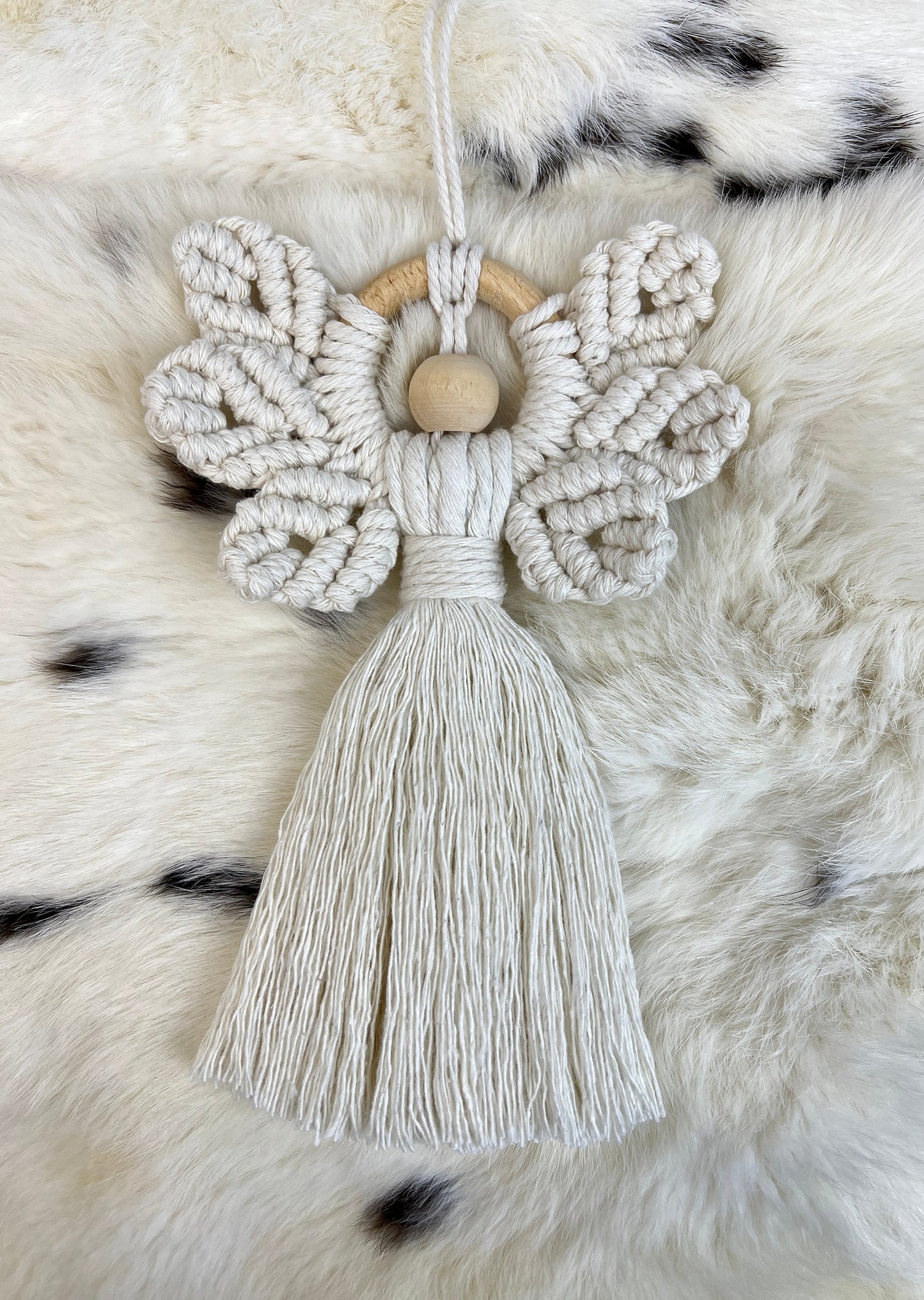 Macrame christmas ornament with tassel on a fur surface